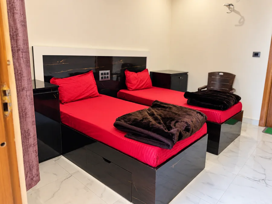 Twin beds in a two-sharing room at Rudra Yogpeeth Rishikesh