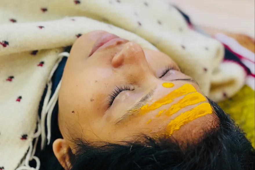 Student resting in deep relaxation while receiving a sound bath at Rudra Yogpeeth, Rishikesh