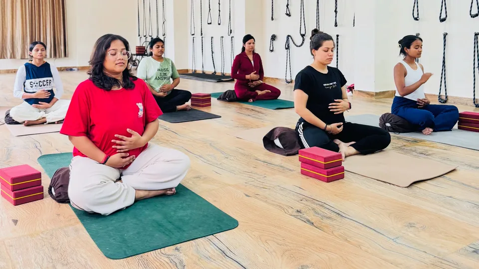 Expectant mothers seated in meditation during a prenatal yoga class at Rudra Yogpeeth, Rishikesh